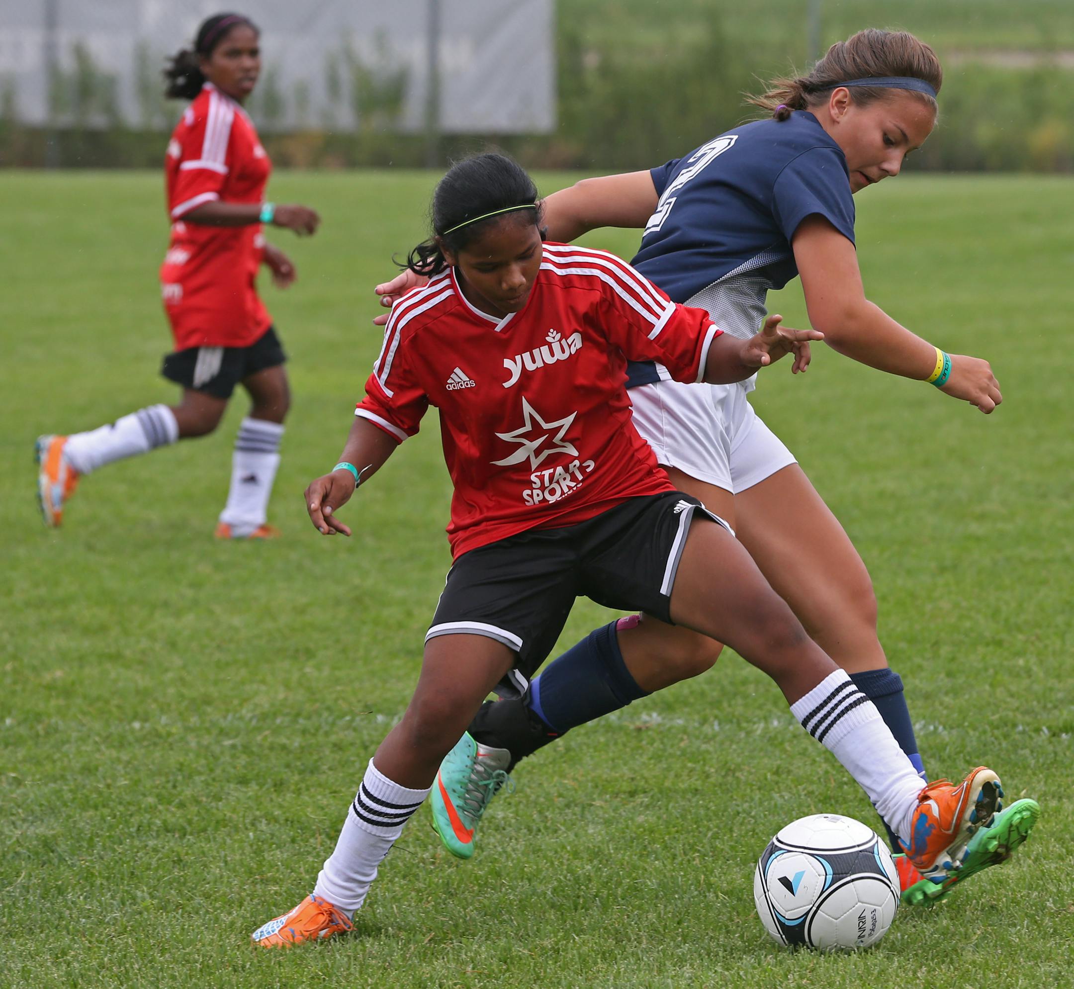The Yuma Supergoats (in red) battled against the Colorado United White on 7/12/14, at the Schwan's Cup. Schwan's Cup feature on the Yuwa Supergoats, a girls' team from India. The team comes from a very poor part of India where girls are married off by age 16. Thus this team is a bit of an anomaly as it defies the female stereotypes in that culture. They've also had quite a lot of backlash and media coverage in India.] We can't use any of the names of the players for security reason, there have b