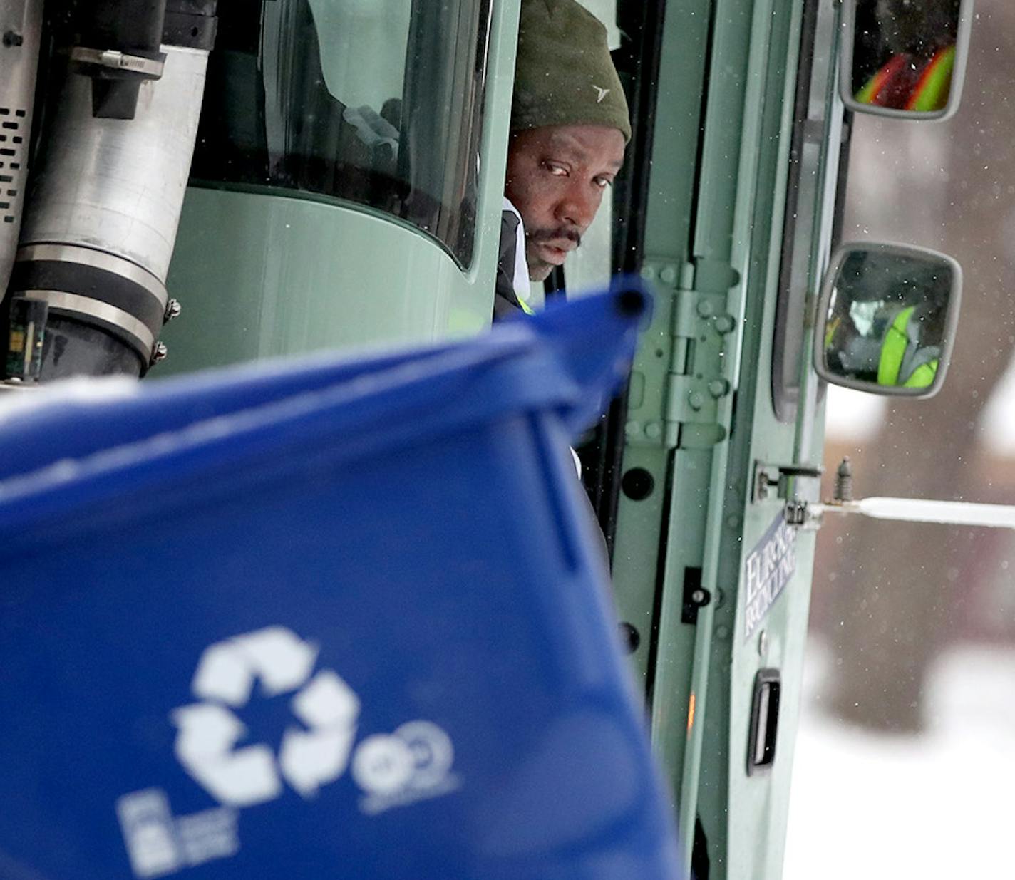 Driver Mourssalou Boukari made a recycling round early Wednesday, January 25, 2017 in St. Paul, MN. The first couple of weeks with new recycling trucks, 80,000 new recycling bins and new recycling pickup days has been frustrating for thousands of St. Paul residents. ] (ELIZABETH FLORES/STAR TRIBUNE) ELIZABETH FLORES &#x2022; eflores@startribune.com