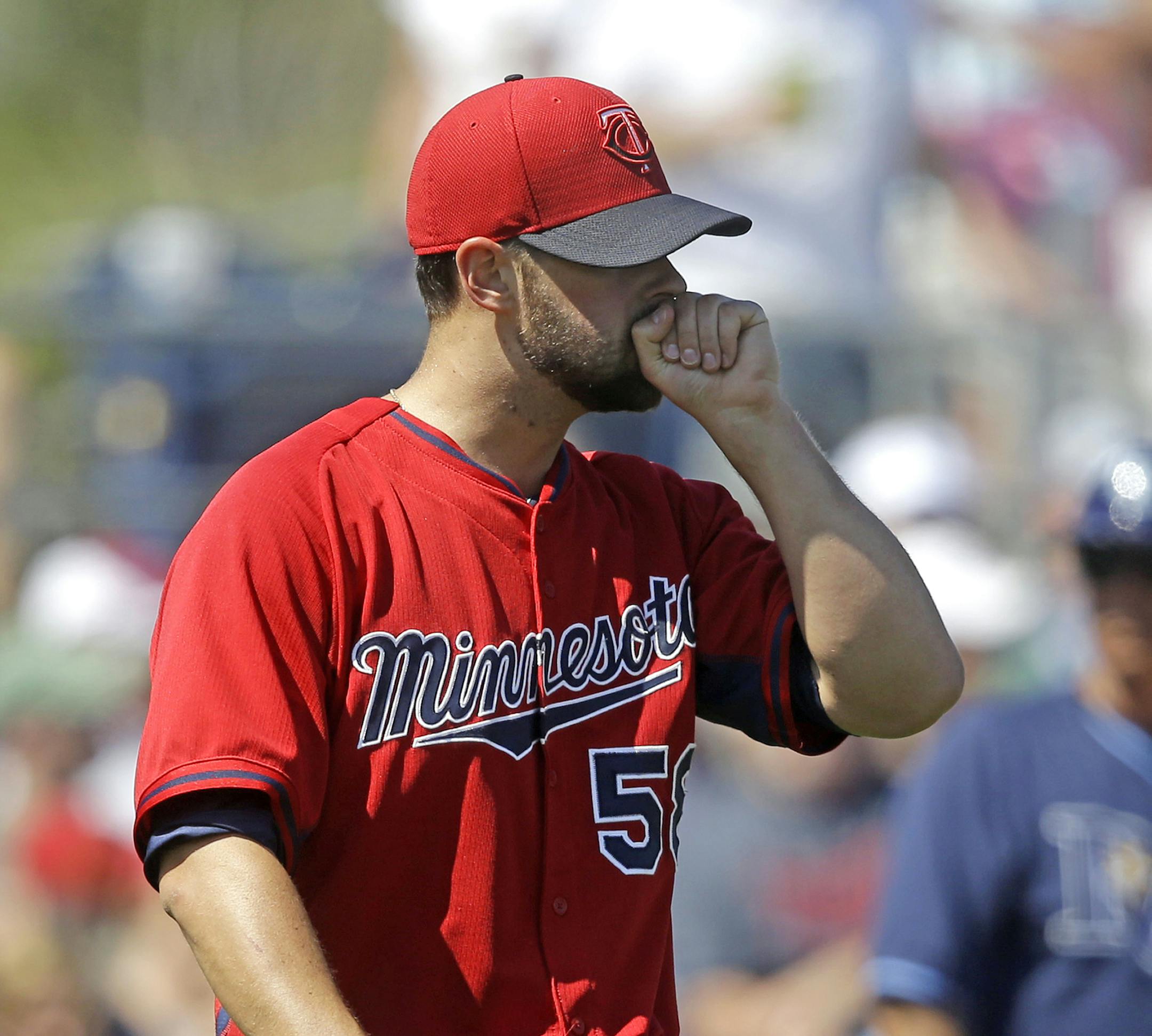 Minnesota Twins pitcher Scott Diamond walks on the mound in the sixth inning an exhibition baseball game against the Tampa Bay Rays in Port Charlotte, Fla., Tuesday, March 11, 2014. The Rays won 7-1. (AP Photo/Gerald Herbert)