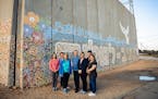 Minnesota legislators standing in front of the “Path to Peace” mosaic within an Israeli agricultural community near the Gaza border.