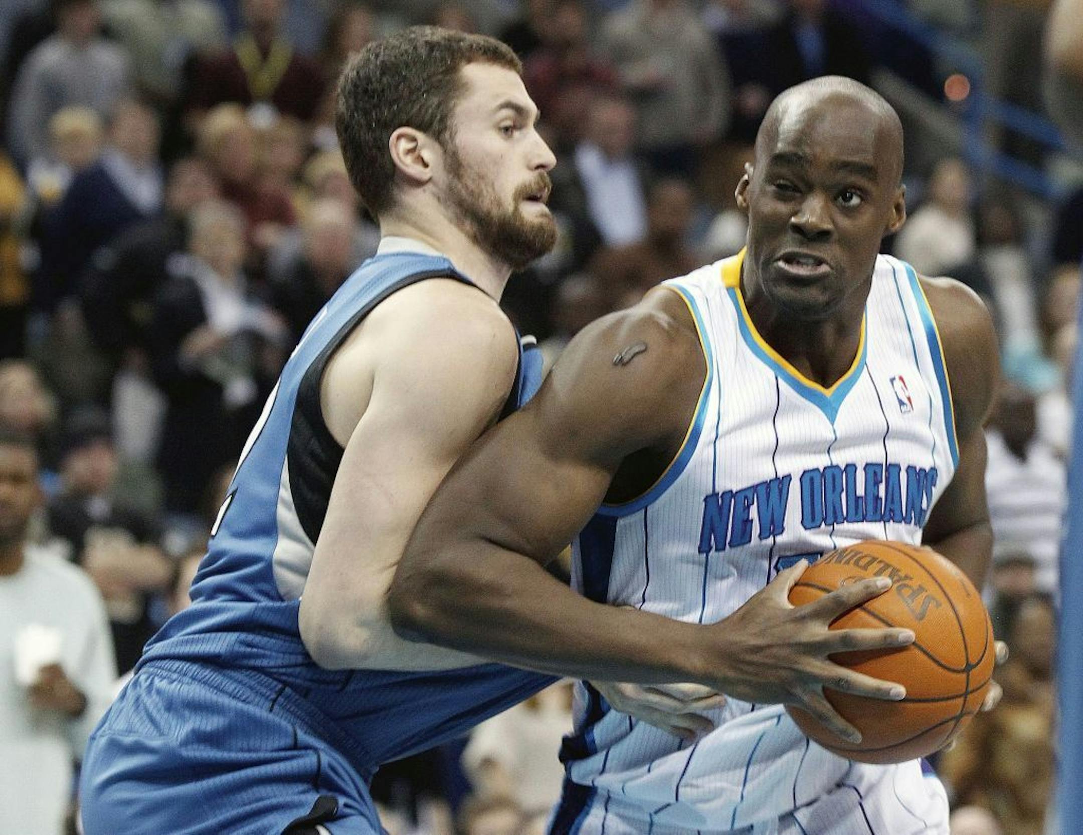 Minnesota Timberwolves power forward Kevin Love (42) defends against New Orleans Hornets center Emeka Okafor (50) during the first half of an NBA basketball game in New Orleans, Friday, Jan. 13, 2012.