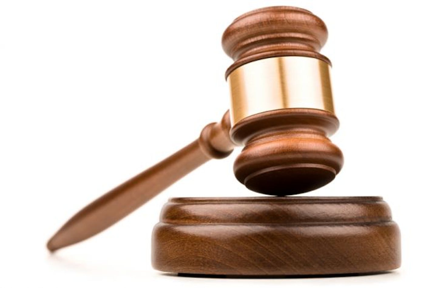 Wood gavel and sounding block on a white background.