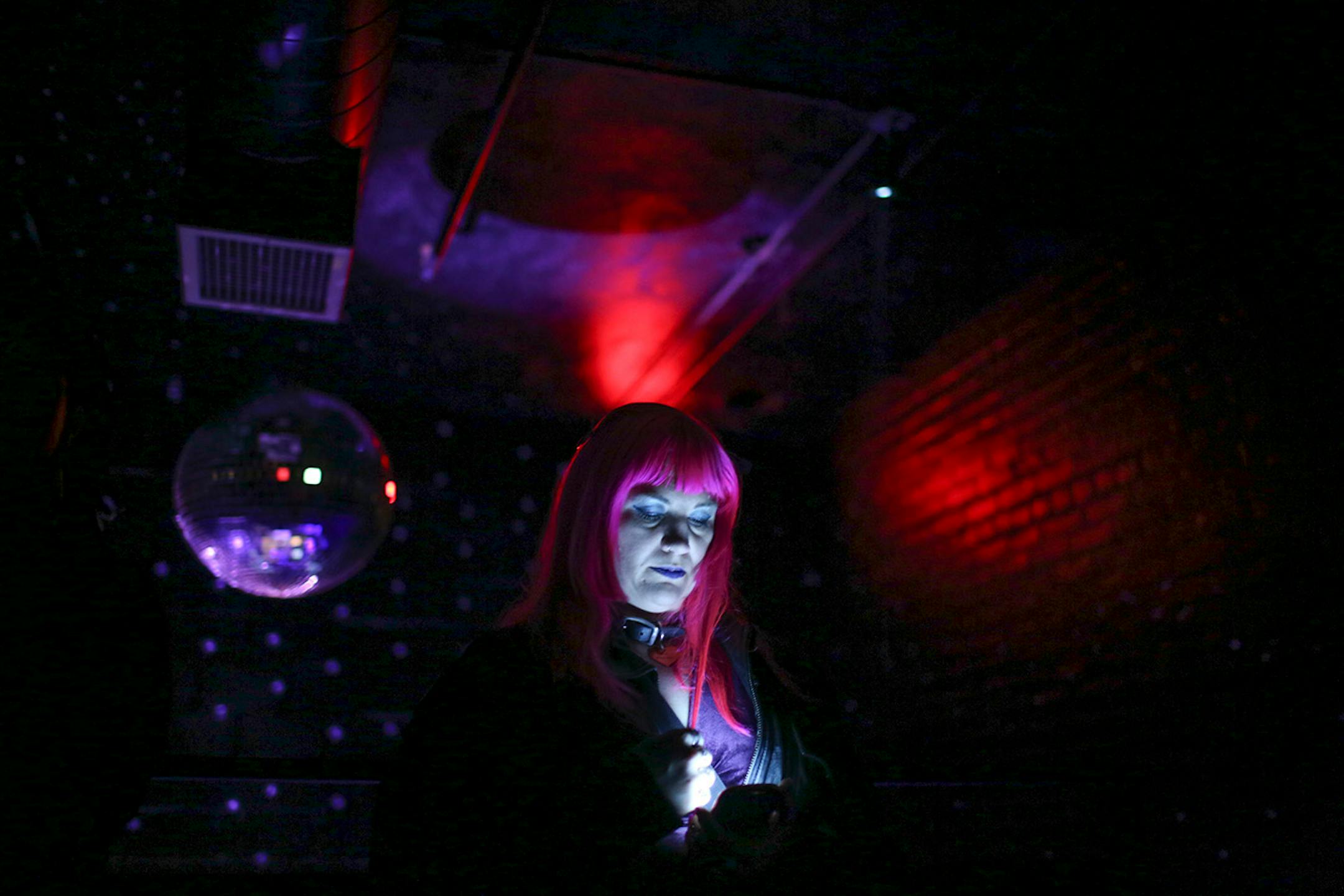 Allie Batts of Oakland, CA read on her phone at the back of The Record Room while listening to poets read at The Prince Purple Poetry Party Wednesday night at First Ave. ] JEFF WHEELER • jeff.wheeler@startribune.com One of the off-site events at the start of the AWP Conference & Bookfair was The Prince Purple Poetry Party Wednesday night, April 8, 2015 in The Record Room at First Ave. in Minneapolis. More than a dozen poets read poems they wrote that were inspired by the music of Prince.