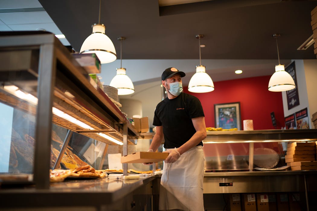 Andrea Pizza owner Frank Gambino boxed an order during the noon hour in March 2021.