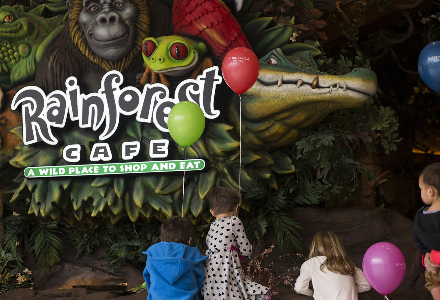 Children observe the familiar electronic alligator (previously in front of the old location) on opening day of the new Rainforest Cafe at the Mall of America in Bloomington, Minn., on Friday, January 22, 2016. ] Elizabeth Page Brumley &#xef; ElizabethBrumley@startribune.com The new Rainforest Cafe in located a floor up from the old restaurant and has a patio and a thunderstorm effect every 20 minutes.