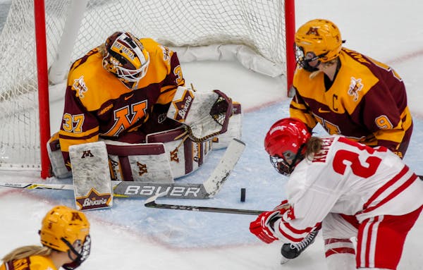 Minnesota goalie Sidney Peters (37) defends against Wisconsin's Claudia Kepler (24) during the second period of an NCAA Frozen Four quarterfinal March