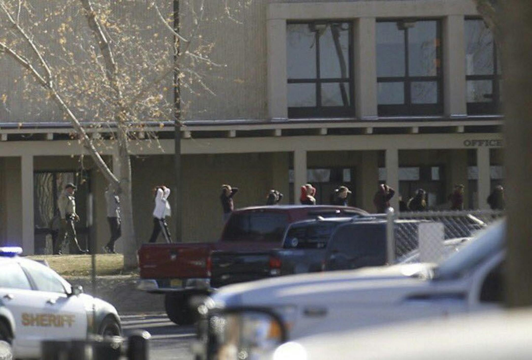 Students are led out of Aztec High School after a shooting Thursday, Dec. 7, 2017, in Aztec, N.M. The school is in the Four Corners region and is near the Navajo Nation.