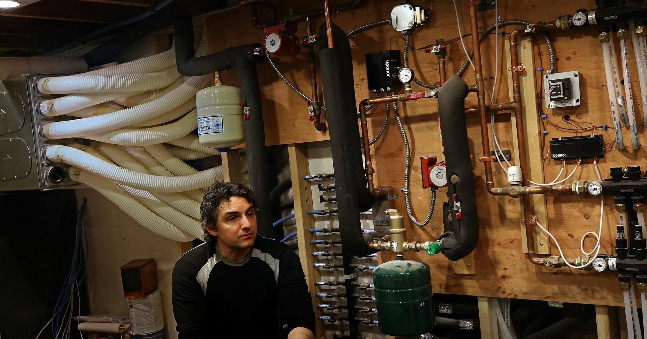 Homeowner Paul Brazelton described some of the apparatus required to operate the hot water heating system that keeps his familyís Minneapolis home warm in the winter. ] JIM GEHRZ ï jgehrz@startribune.com / Minneapolis, MN / January 25, 2014 / 1:00 PM BACKGROUND INFORMATION: The Brazelton family lives in a home that has no furnace, thanks to Passivhaus technology.