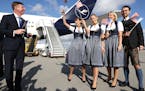 Timothy Liston, U.S. Consul General in Munich, smiled with a Lufthansa crew in traditional Bavarian costume next to an Airbus A350-900, prior to a Luf