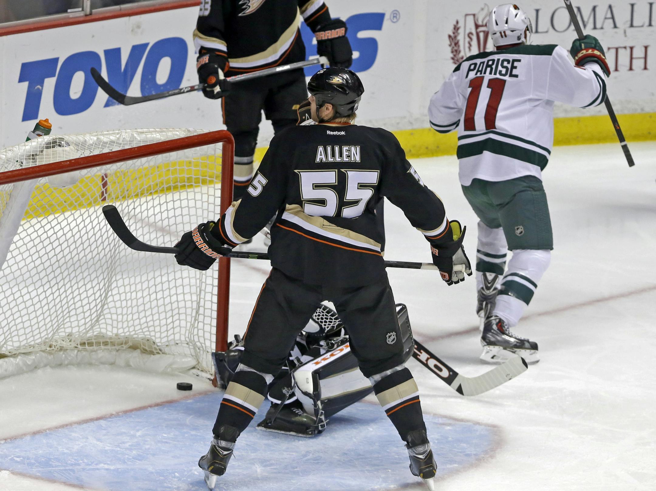 Minnesota Wild left winger Zach Parise (11) celebrates a goal by right winger Jason Pominville, not shown, over Anaheim Ducks goalie Jonas Hiller (1), of Switzerland, rear, and defenseman Bryan Allen (55) in the first period of an NHL hockey game in Anaheim, Calif.,Tuesday, Jan. 28, 2014. The Wild won, 4-2. (AP Photo/Reed Saxon)