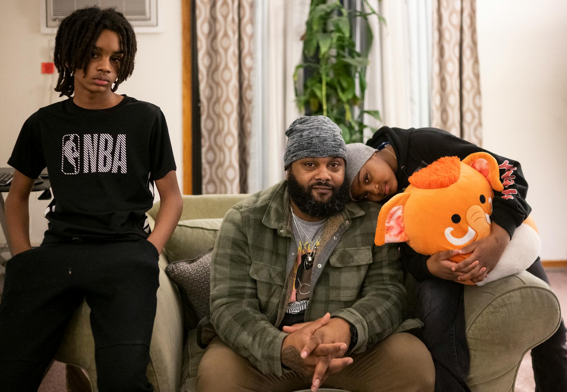 Cameron Taylor sits for a portrait with his 9-year-old daughter Isis and 11-year-old son Nasir at his girlfriend's apartment in Bloomington. Taylor was convicted of felony marijuana possession a decade ago.