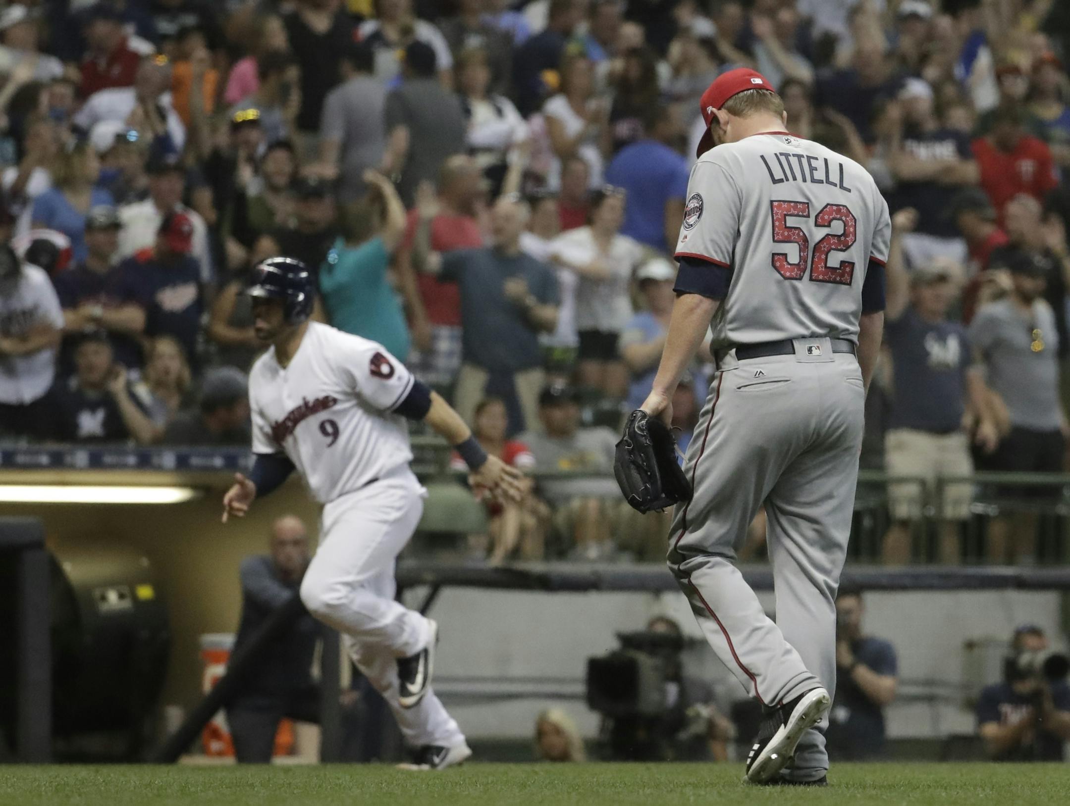 Minnesota Twins' reliever Zack Liittell walks back to the dugout as Milwaukee Brewers' Manny Pina scores on a walk off walk during the 10th inning of a baseball game Monday, July 2, 2018, in Milwaukee. (AP Photo/Morry Gash)