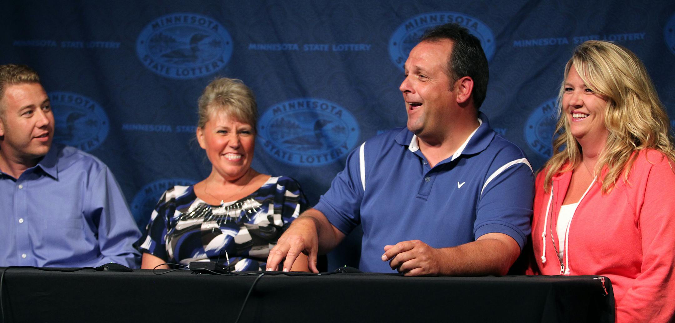 Paul White, third from left, of Ham Lake, with his significant other Kim VanReese, far right, and coworkers Ron and Nancy Bowen, holds a press conference after claiming a $149.4 million Powerball jackpot at the Minnesota State Lottery office in Roseville, Minn., on Thursday, August 8, 2013. ] (ANNA REED/STAR TRIBUNE) anna.reed@startribune.com (cq)