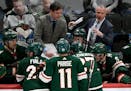 Wild interim head coach Dean Evason speaks to his players along with assistant coach Darby Hendrickson during a timeout against Capitals last weekend.