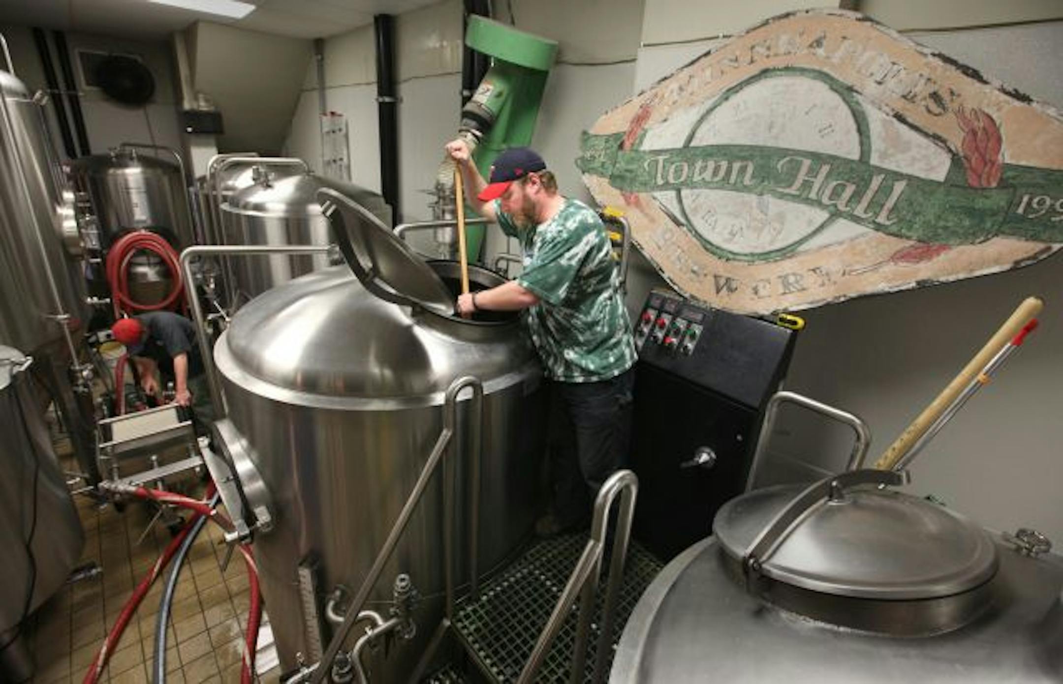 Mike Hoops stirs the pot in the Town Hall Brewery facility.