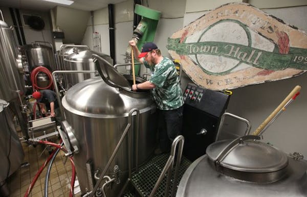 Mike Hoops stirs the pot in the Town Hall Brewery facility.