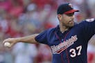 Minnesota Twins starting pitcher Mike Pelfrey throws in the second inning of a baseball game against the Cincinnati Reds, Monday, June 29, 2015, in Ci