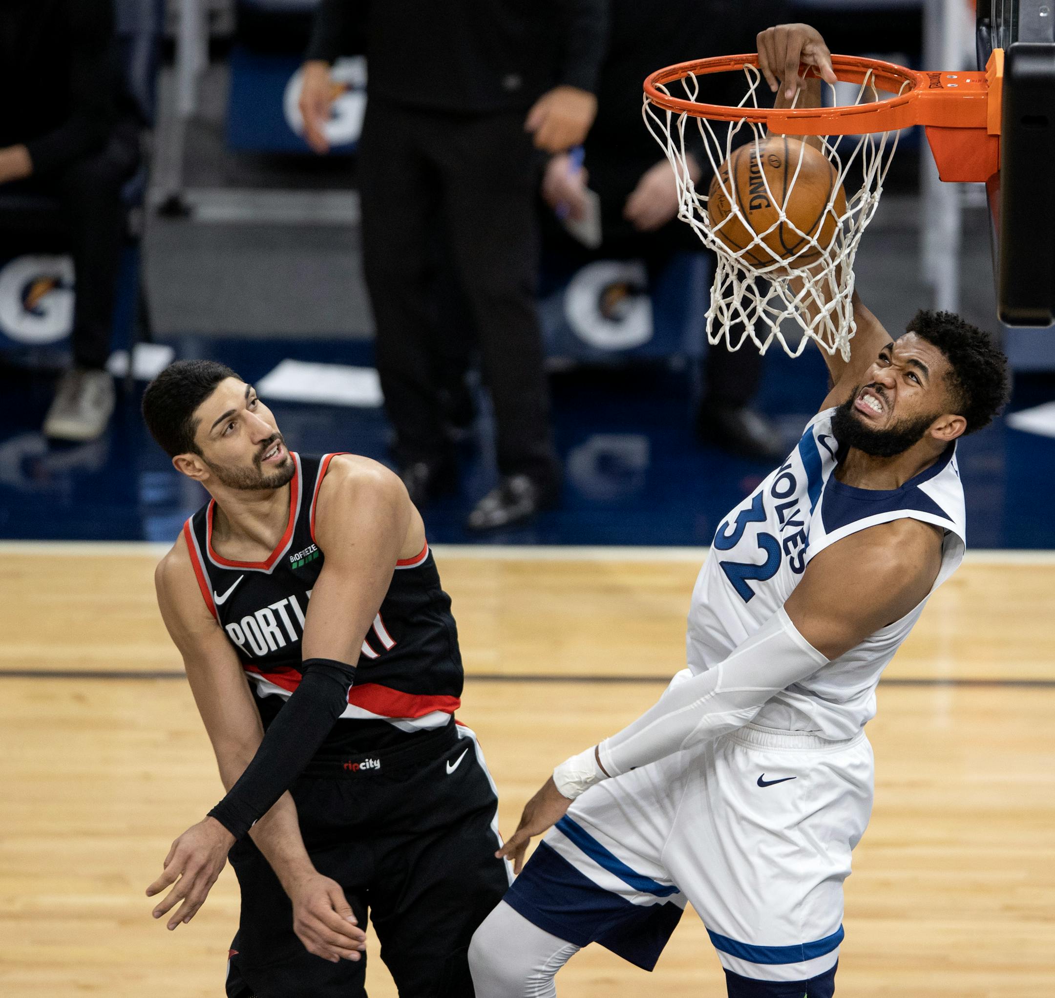 Karl-Anthony Towns (32) of the Minnesota Timberwolves dunked the ball while defended by Enes Kanter (11) of the Portland Trailblazers in the second quarter.