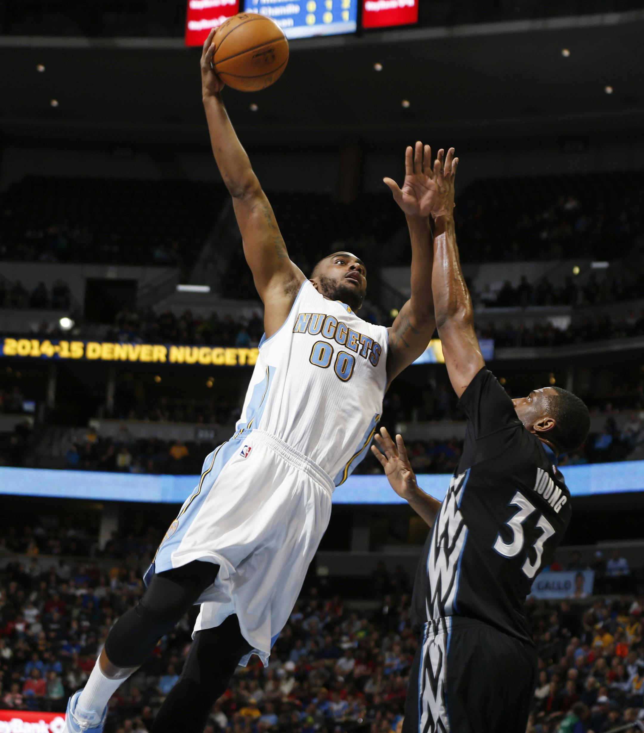 Denver Nuggets forward Darrell Arthur shoots over Minnesota Timberwolves forward Thaddeus Young during the third quarter of an NBA basketball game Saturday, Jan. 17, 2015, in Denver. The Timberwolves won 113-105. (AP Photo/David Zalubowski)