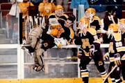 Gophers goalie Robb Stauber and teammates including Randy Skarda (10) celebrate a 7-4 victory against Maine before playing Harvard in the 1989 NCAA ch