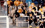 Gophers goalie Robb Stauber and teammates including Randy Skarda (10) celebrate a 7-4 victory against Maine before playing Harvard in the 1989 NCAA ch