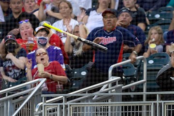 Fans try to avoid a bat that slipped out of the hands of Drew Waters (6) of the Kansas City Royals in the third inning Wednesday, September 14, 2022, 