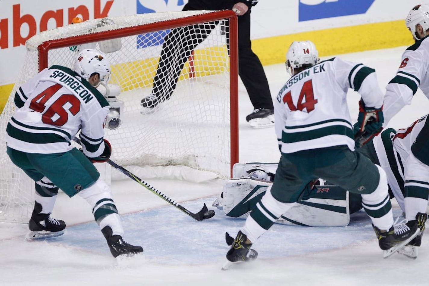 Minnesota Wild's Jared Spurgeon (46) saves a Winnipeg Jets shot that got past goaltender Devan Dubnyk (40) as Joel Eriksson Ek (14) and Daniel Winnik (26) defend during the third period of Game 1 in an NHL hockey first-round playoff series Wednesday, April 11, 2018, in Winnipeg, Manitoba.