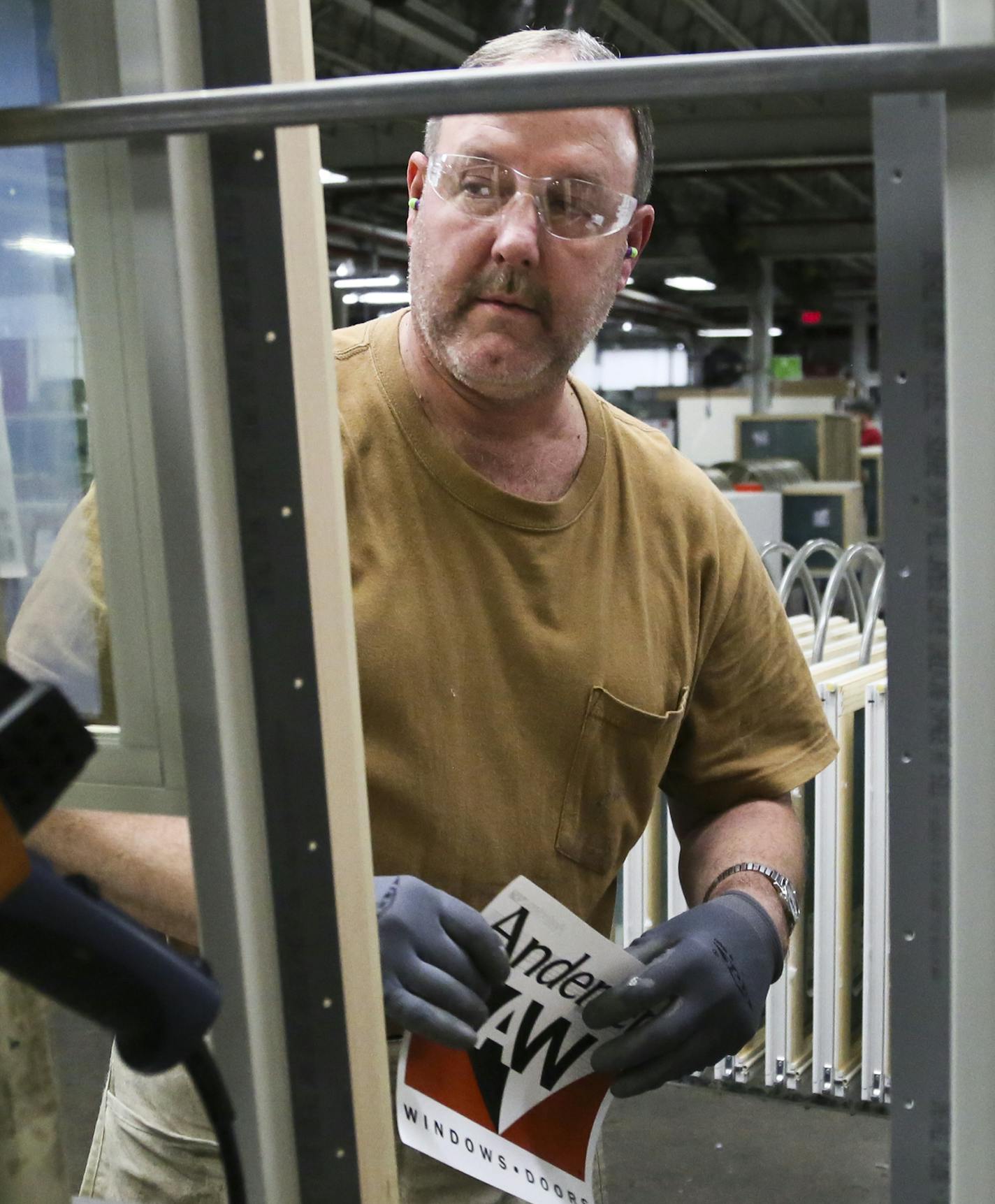 Andersen Windows uniline assembly employee Mike Rowley does a visual inspection before placing an Andersen Windows sticker oni a doublehung frame Wednesday, April 30, 2014, in Bayport MN.](DAVID JOLES/STARTRIBUNE) djoles@startribune Andersen Windows is set to announce an $18 million expansion to its plant in Bayport. The move will create 100 jobs for the riverside town, with an average pay rate of $19 an hour. Andersen employs about 2,400 workers in Bayport and about 9,000 in North America. The