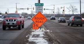 Shepard Road in St. Paul was reduced from 50 to 35 MPH because of all the potholes, cars are seen driving on Shepard Road near Davern Street on Friday
