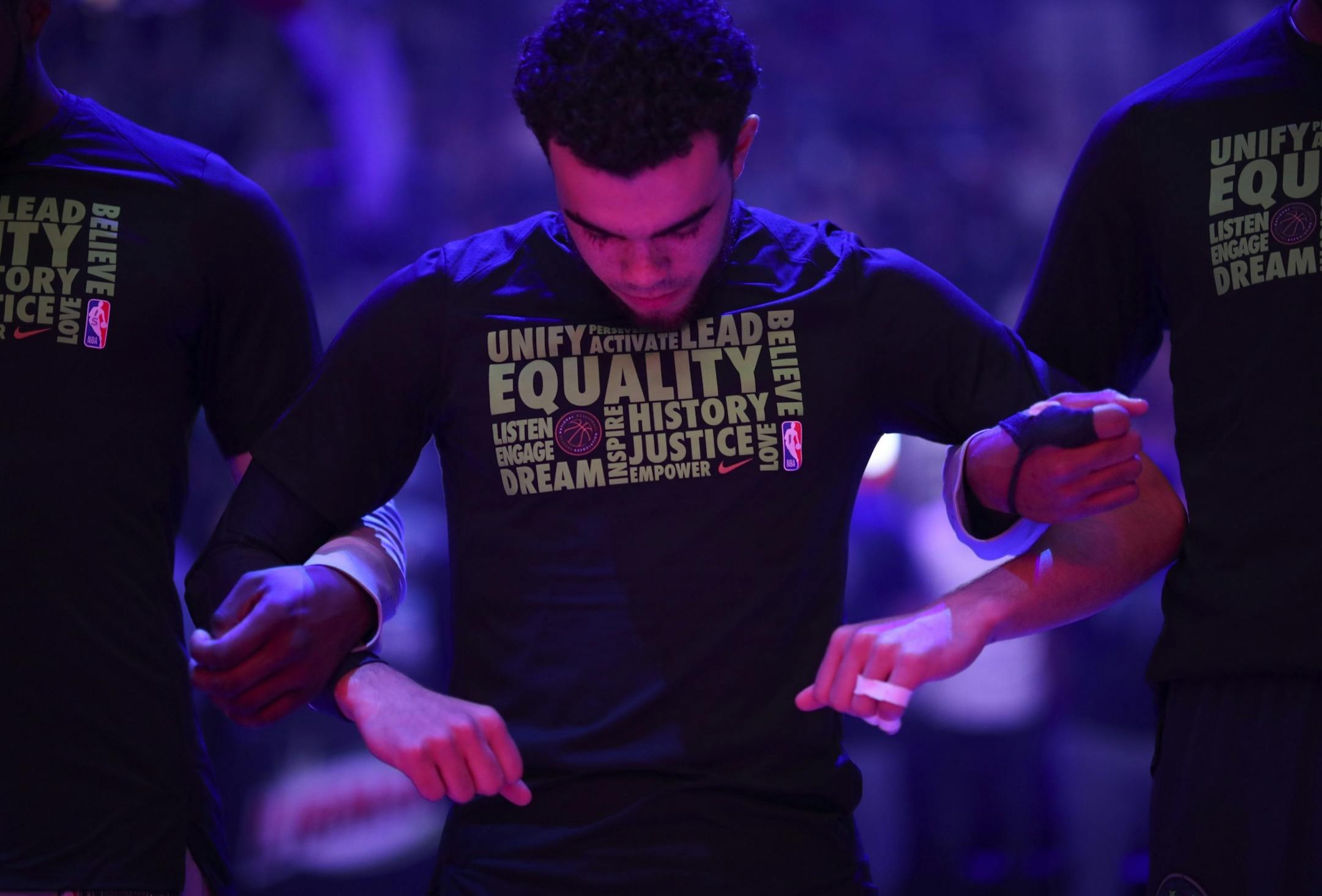 The Minnesota Timberwolves, including guard Tyus Jones, linked arms for the singing of the national anthem before the game.