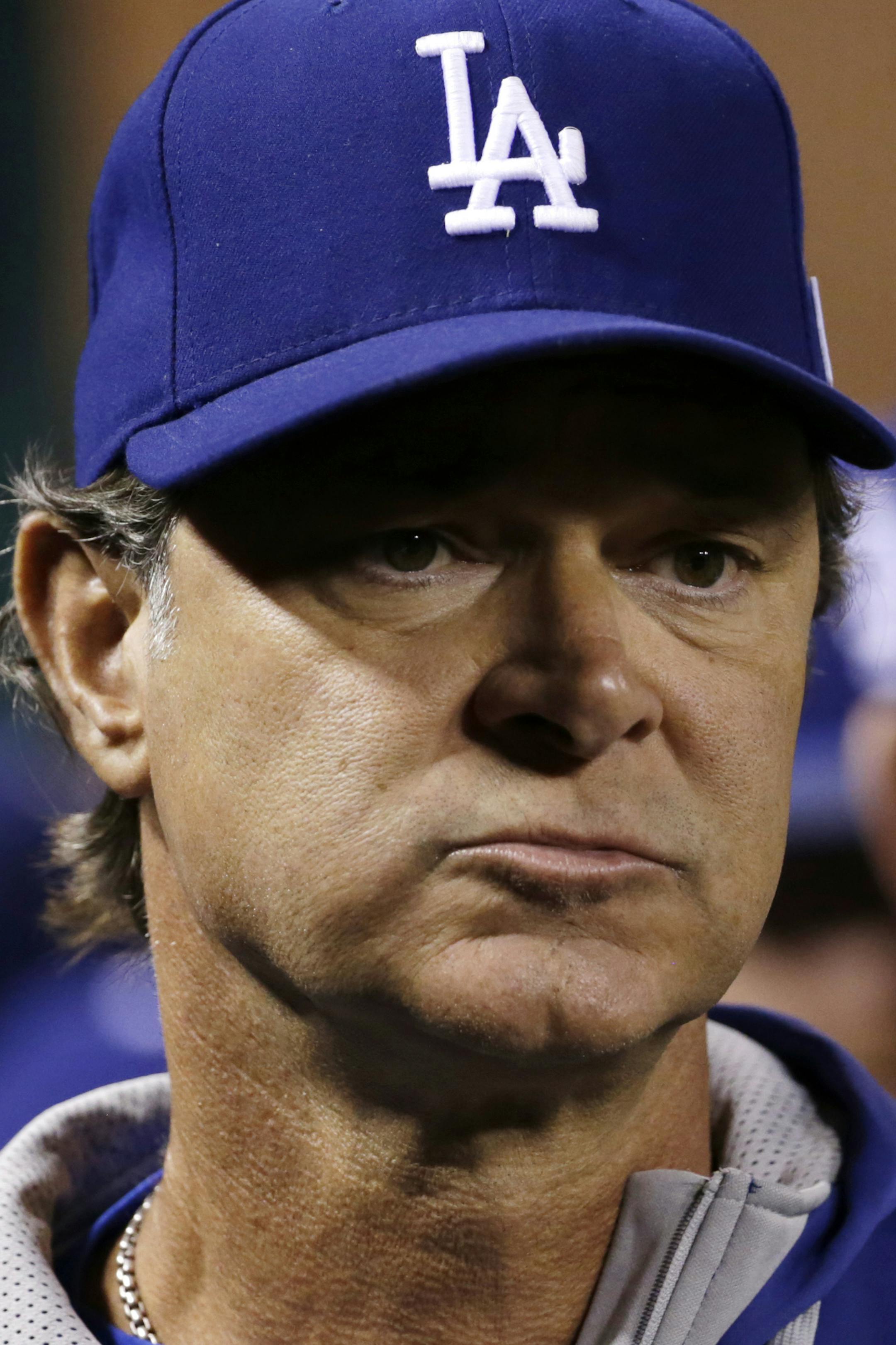 Los Angeles Dodgers manager Don Mattingly walks in the dugout before Game 3 of baseball's NL Division Series against the St. Louis Cardinals, Monday, Oct. 6, 2014, in St. Louis. (AP Photo/Charles Rex Arbogast) ORG XMIT: MOCN111
