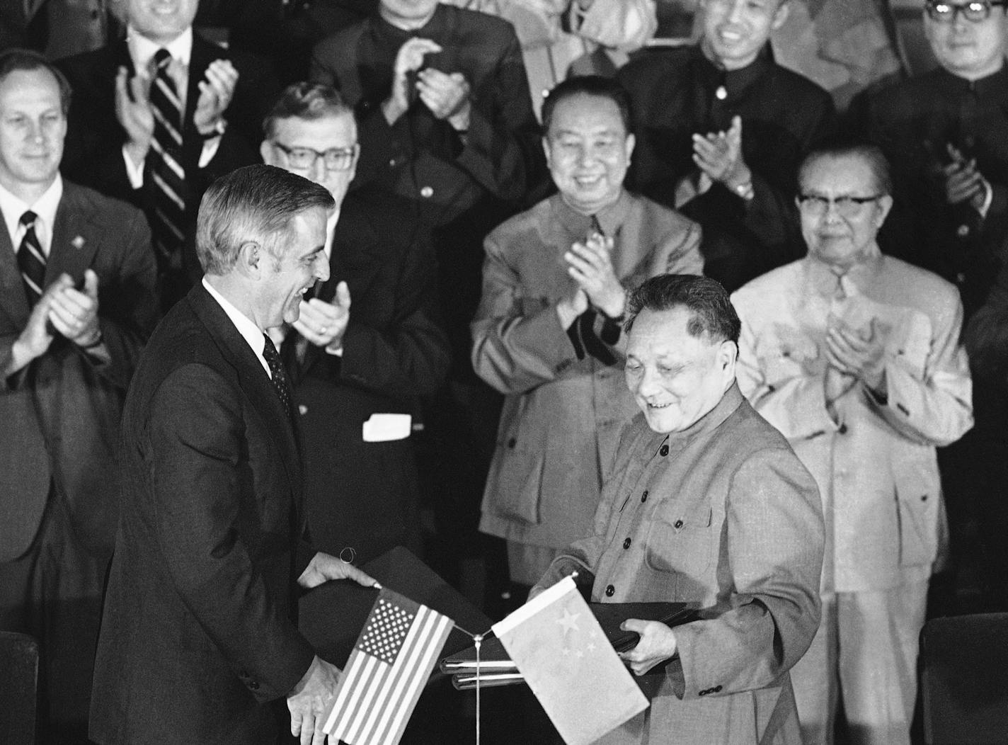 Vice President Walter Mondale and Chinese Vice premier Deng Xiaoping exchange Cultural and Hydroelectric agreements after a signing ceremony in Peking on Tuesday, August 28, 1979. Looking on, from left: Amb. Leonard Woodcock, Chinese Premier Hua Guofeng and Foreign Minister Huang Hua. (AP Photo/Daugherty)