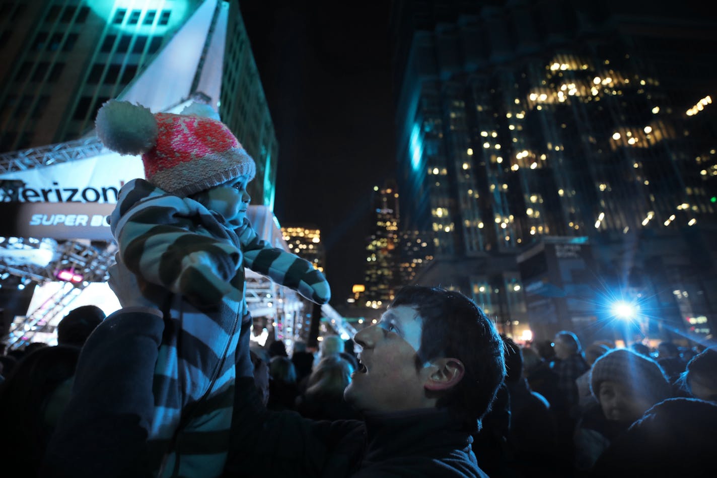 Dan Hodgson held his one-year-old daughter Brenna as they joined thousands of people who waited for Idina Menzel to sing Let it go, from the movie Frozen at the Super Bowl Live kickoff show on the Nicollet Mall Friday January 27, 2017 in Minneapolis, MN