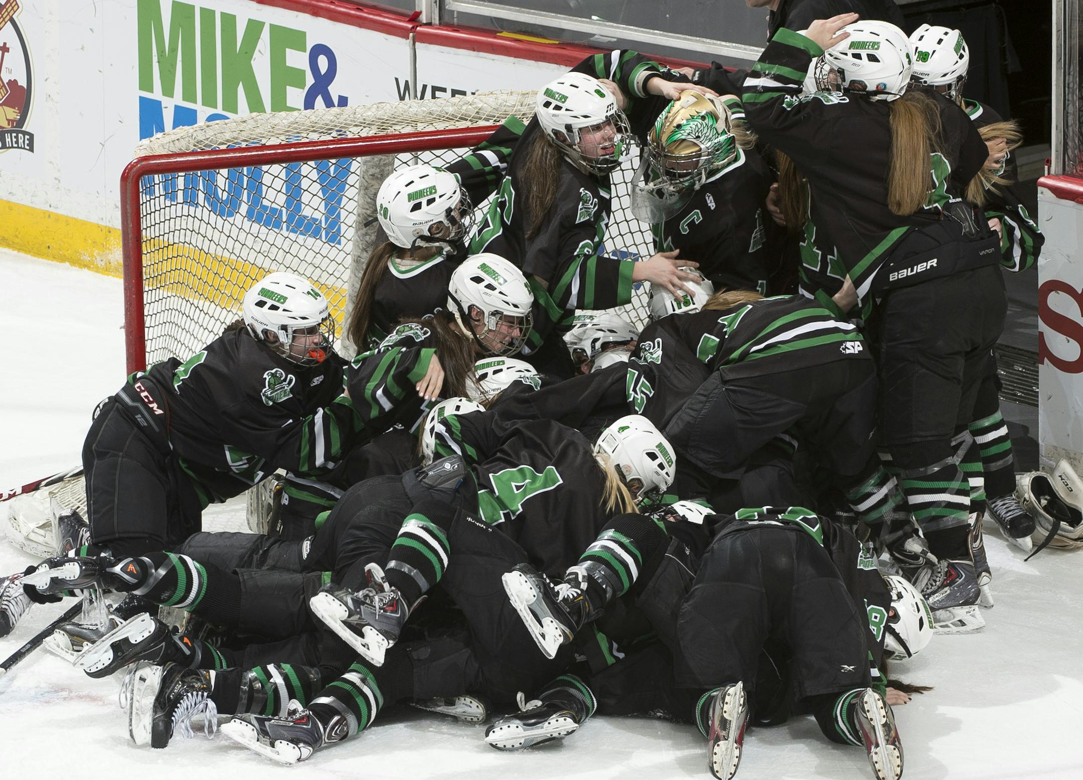 Hill-Murray players pile on top one another while celebrating their 2-1 victory over Minnetonka in the Class 2A Girls' Hockey Championship game. ] (Aaron Lavinsky | StarTribune) Hill-Murray plays Minnetonka in the Class 2A Girls' Hockey Championship game on Saturday, Feb. 21, 2015 at Xcel Energy Center in St. Paul.