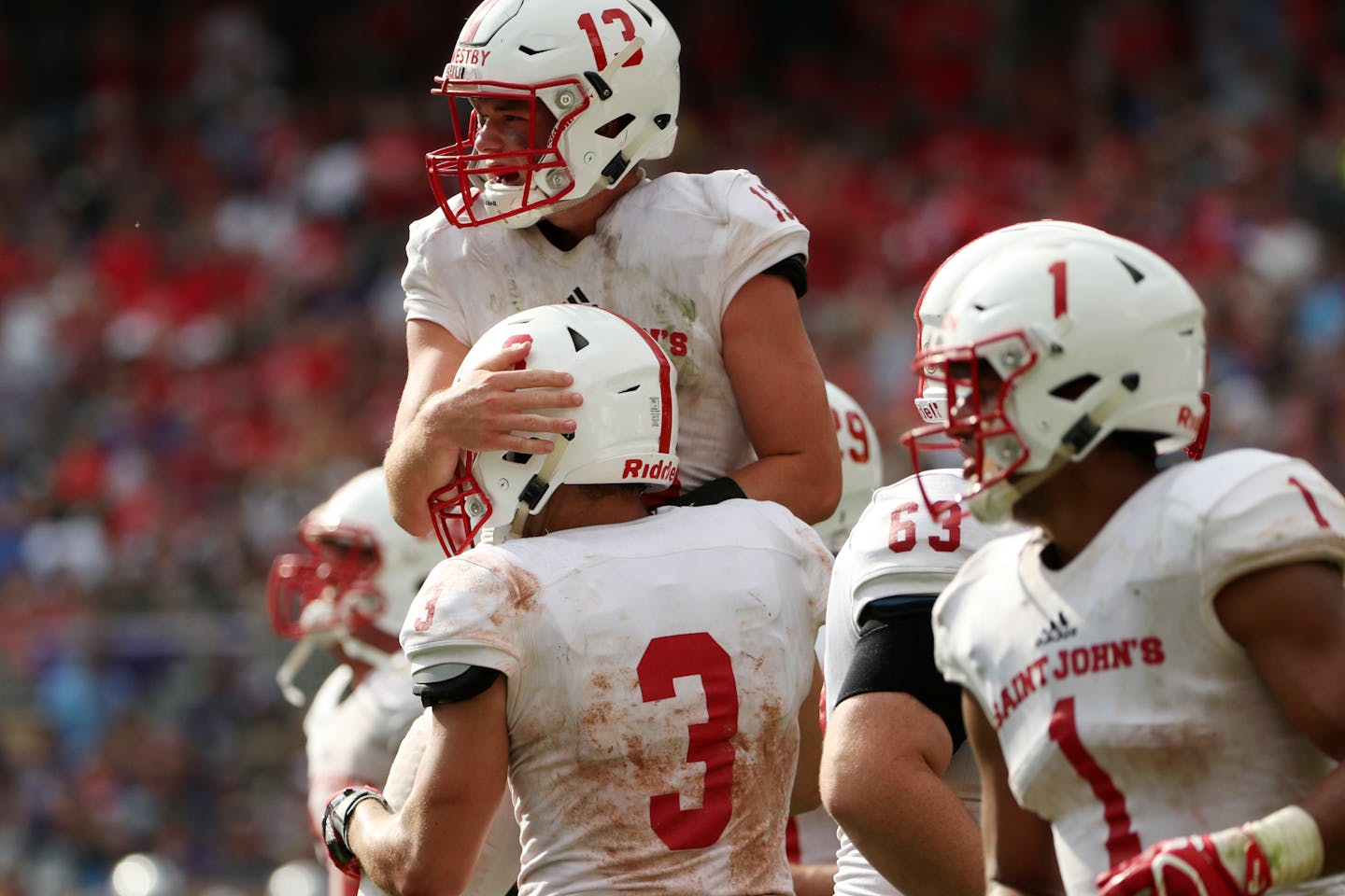 St. John's defensive back Sam Westby (13) was congratulated by Dusty Krueger (3) during a game in 2017