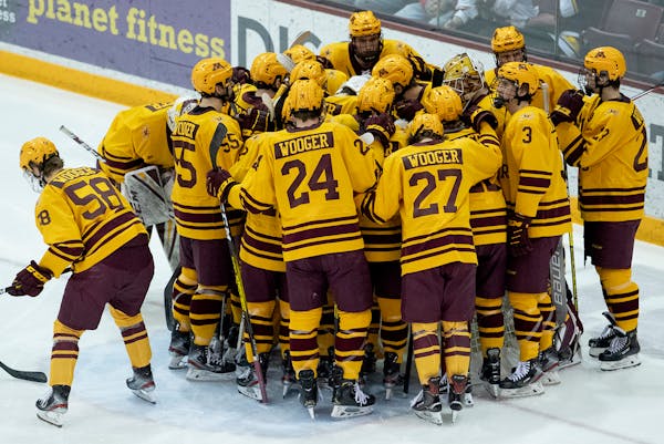 Gophers players wearing Wooger jerseys huddled up before the start of Sunday's game.