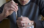 A Type 1 diabetes patient filling his insulin pump at home, in American Fork, Utah, Feb. 26, 2017. Consumers whose drug benefits are managed by Expres