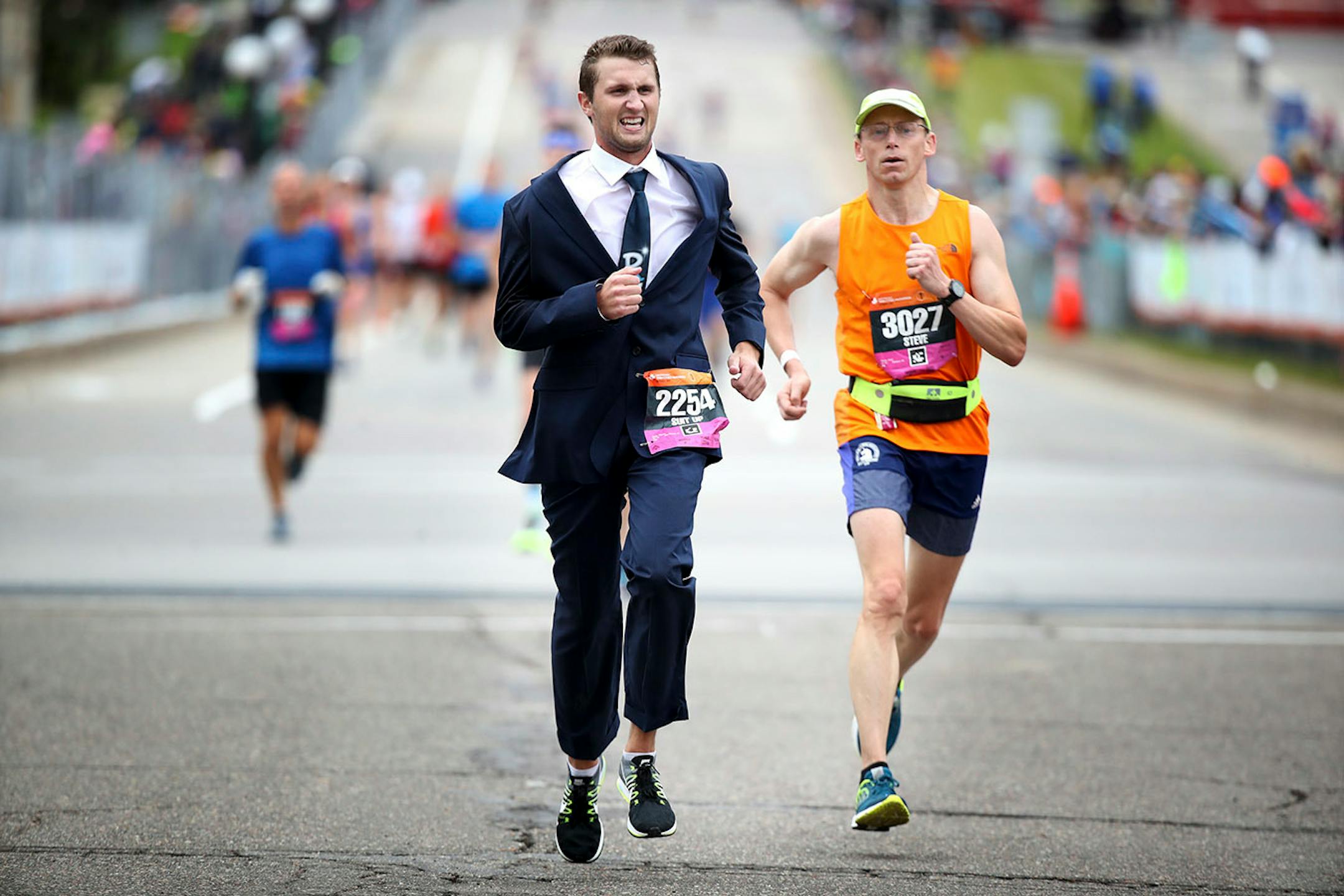 Steve Dado of Stillwater, wore a business suit at the finish line during the Twins Cities Marathon Sunday October 1,2017 in St. Paul, MN.