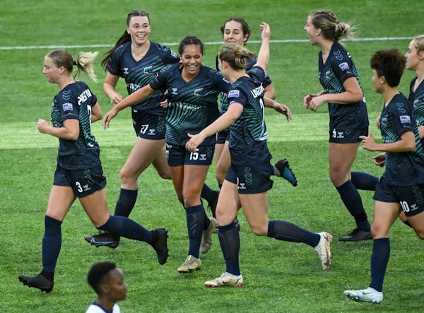 Minnesota's Shelby Hopeau (15) celebrates with teammates after scoring a goal against Green Bay during a game on May 26.