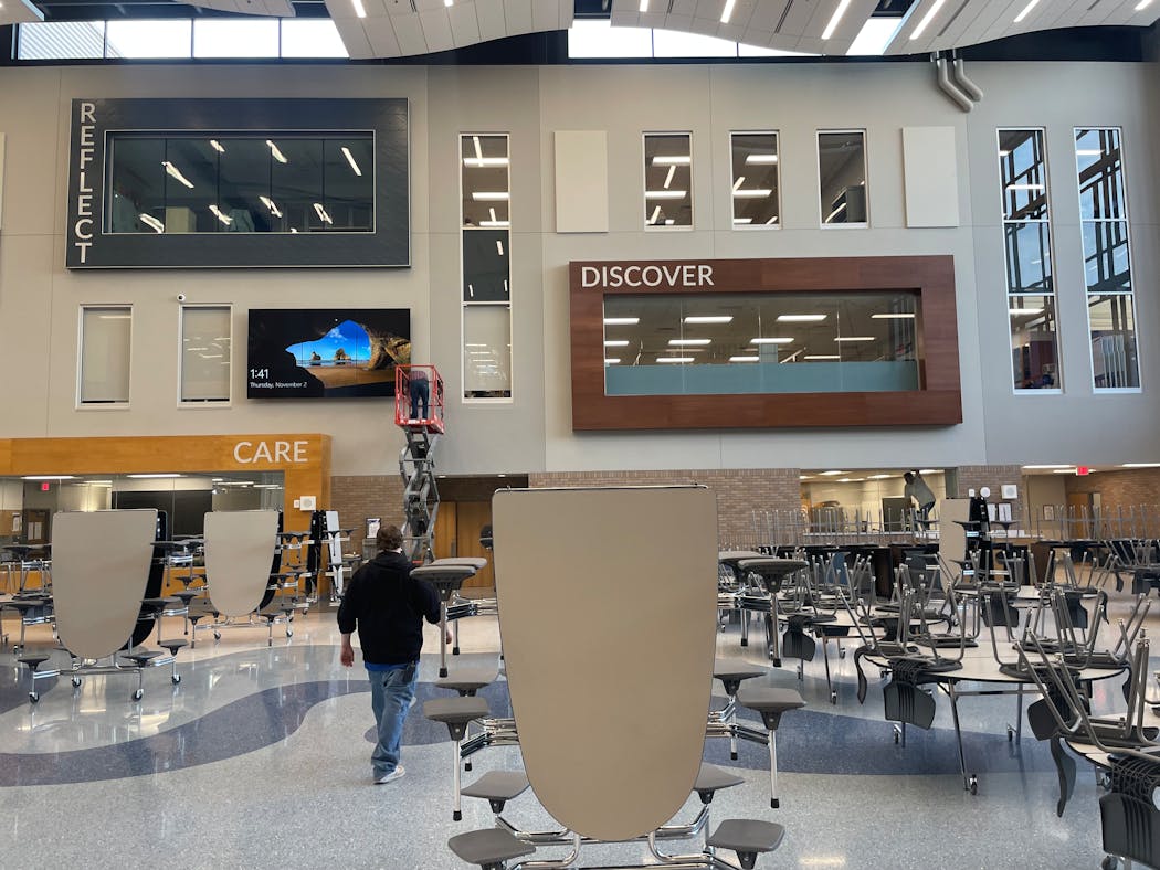 All of the classrooms at the new Owatonna High School are walled with floor-to-ceiling glass, the way most modern offices are. In the common area, some of the classrooms are framed with one-word directives like “Discover.”