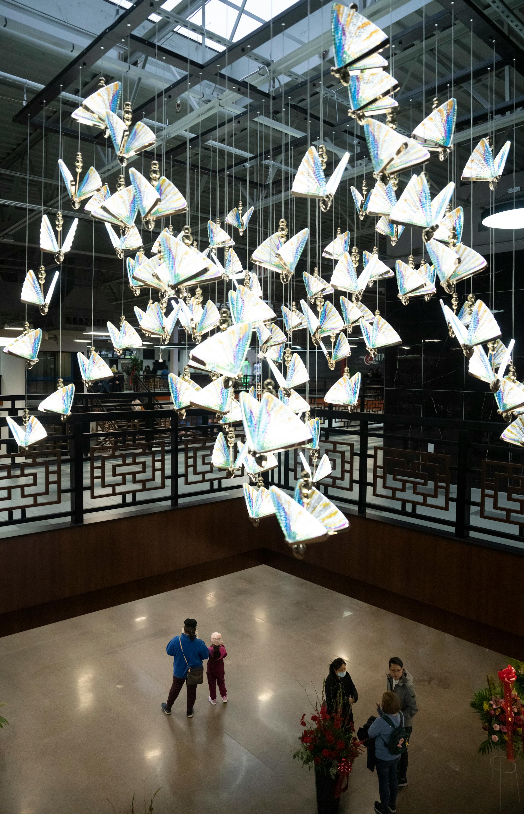 A chandelier of butterflies hangs over the entrance of the new Asia Mall.