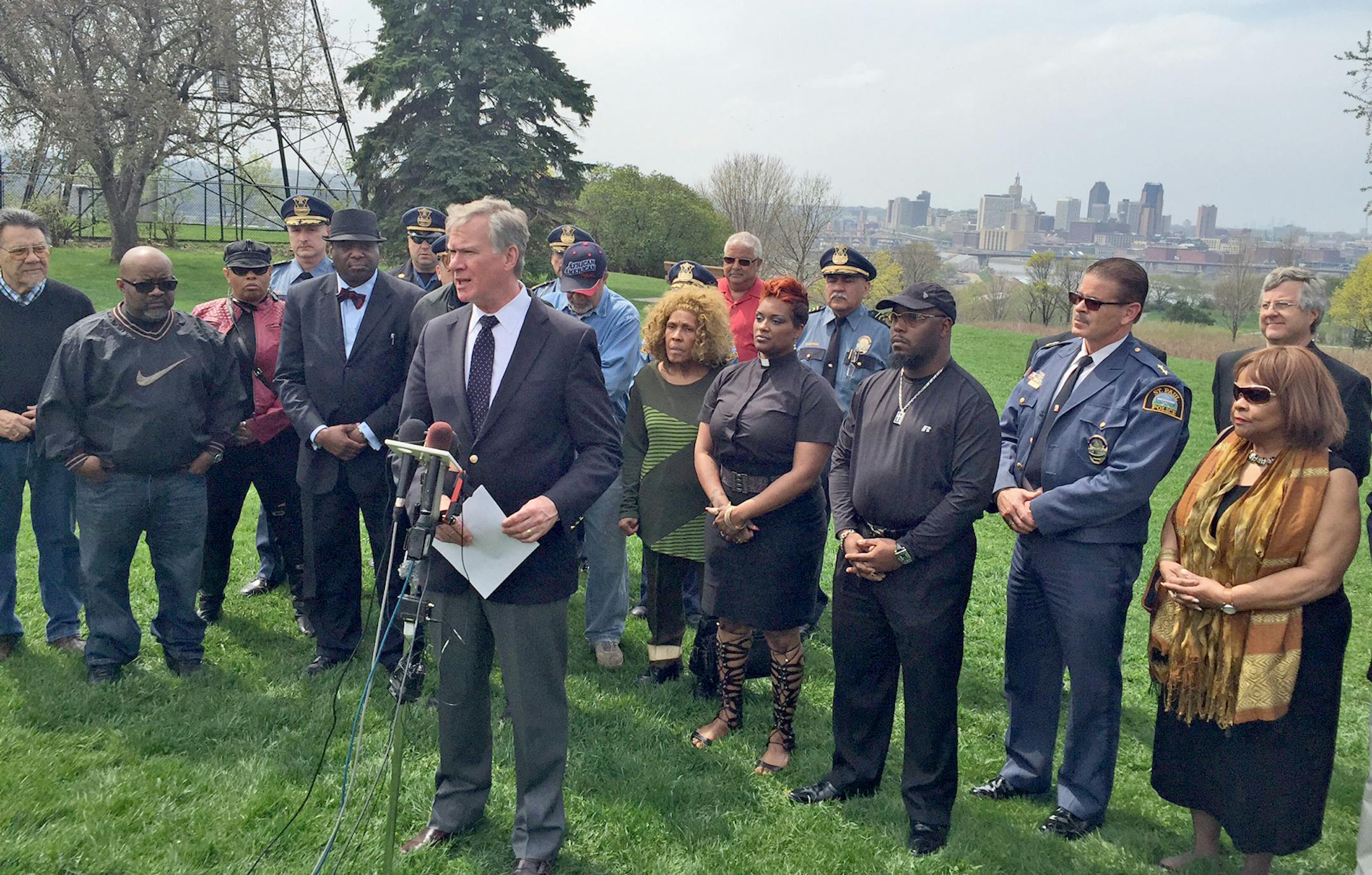 St. Paul mayor Chris Coleman and other community leaders stand together to address fatal gunfire at Indian Mounds Regional Park in St. Paul.