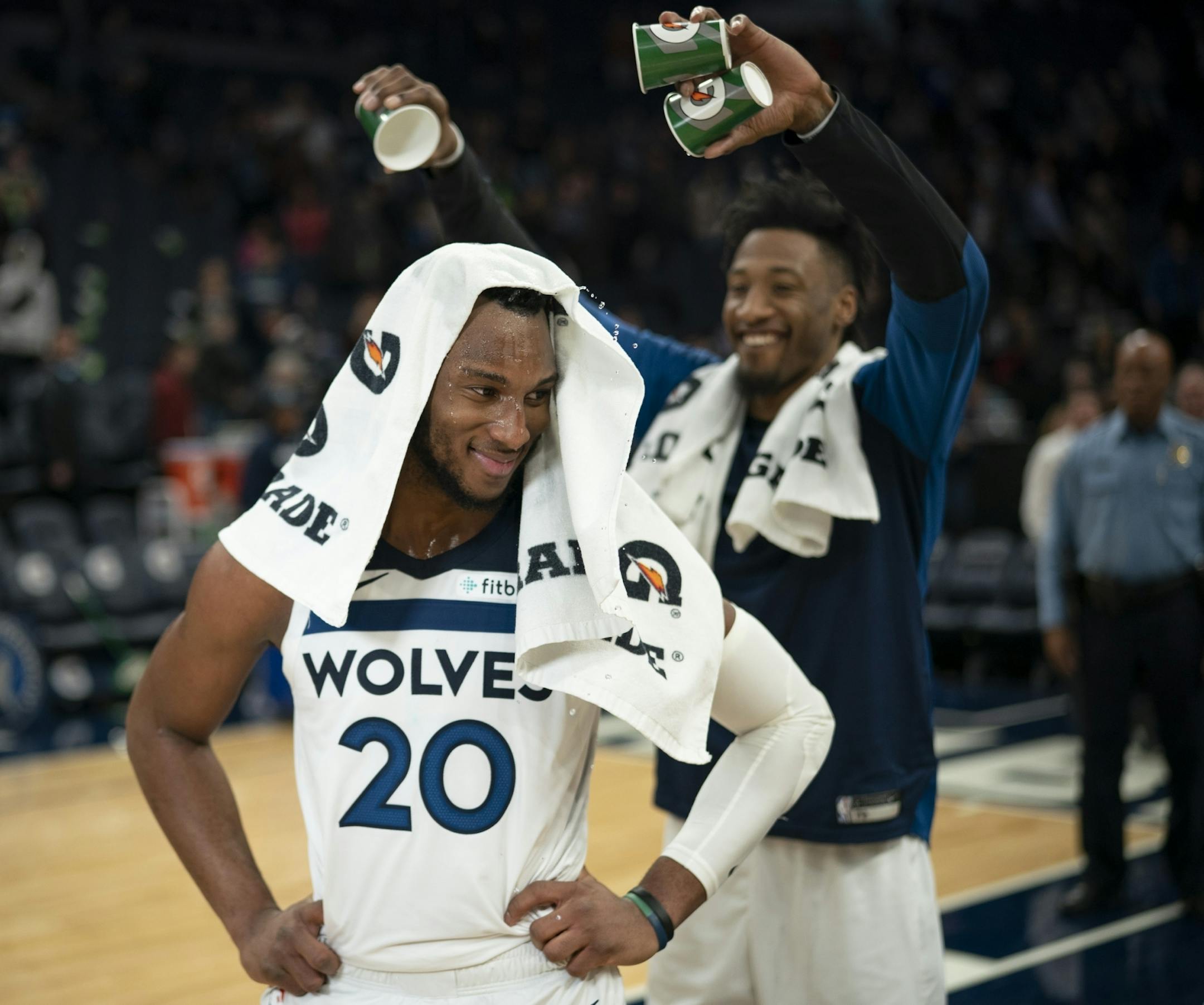 Josh Okogie turned to look back at his Timberwolves teammate Robert Covington after receiving a mini-Gatorade shower from him while he was being interviewed by Fox Sports North's Marney Gellner after the game.