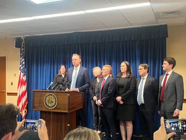 Joseph Thompson, Assistant U.S. Attorney, surrounded by other prosecutors on the Feeding Our Future case, speaks during a press conference at the Unit