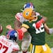 Aaron Rodgers (12) is sacked on the final play of the game during Sunday’s 27-22 loss.