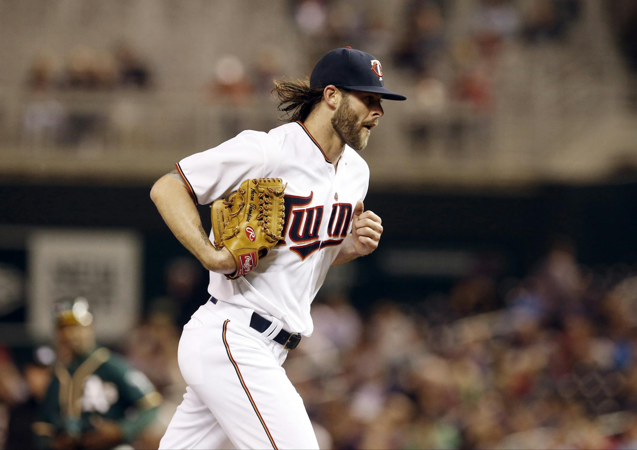 Minnesota Twins relief pitcher Aaron Thompson heads for the dugout after he was pulled in the eighth inning of a baseball game, Monday, May 4, 2015, in Minneapolis. The Twins won 8-7. (AP Photo/Jim Mone) ORG XMIT: MIN2015050617581020