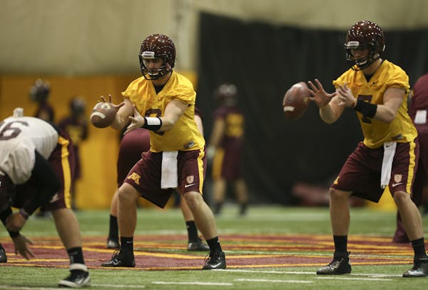 Likely starting quarterback Philip Nelson, left, and possible backup, Mitch Leidner, took snaps during practice in March.