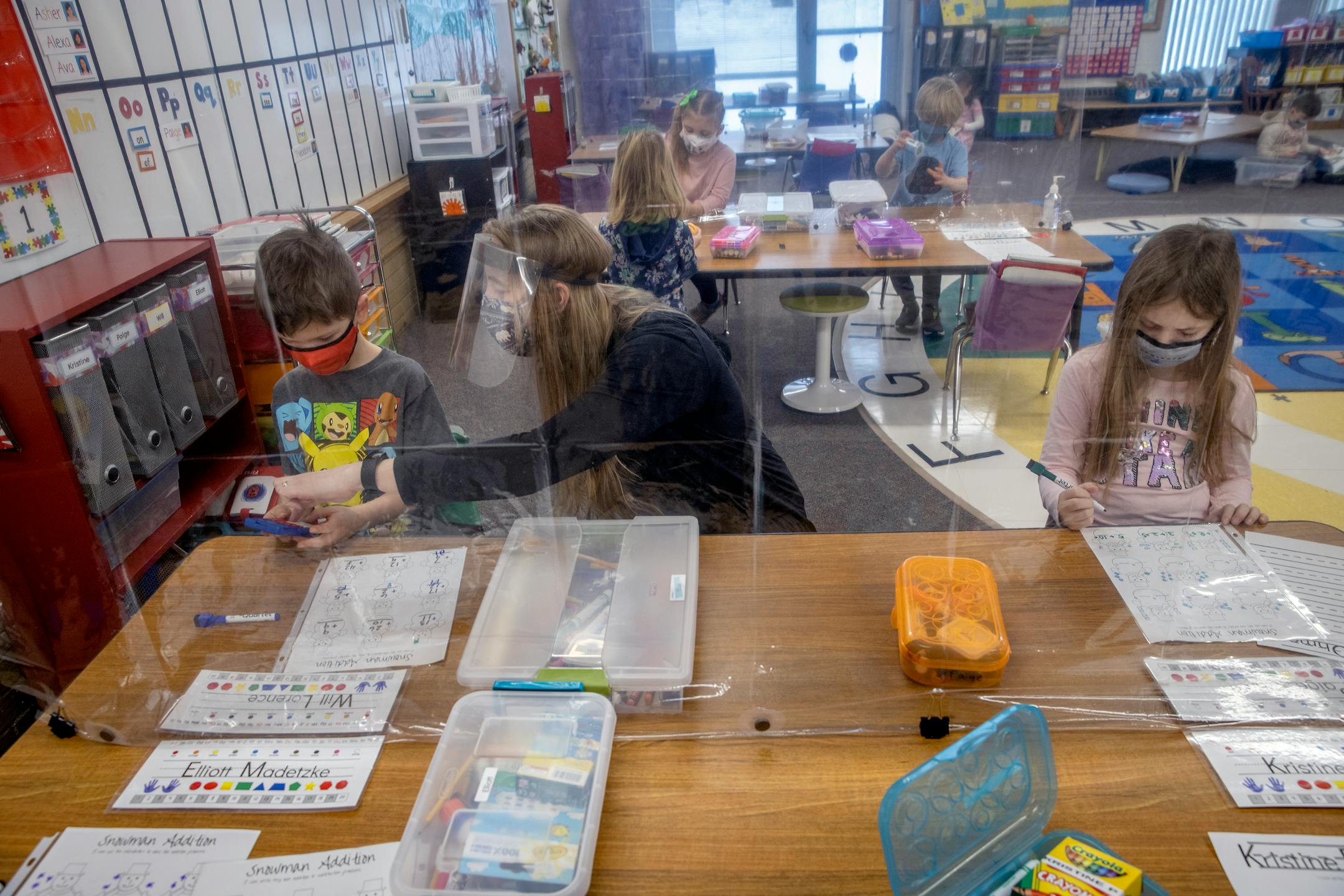 Poplar Elementary School kindergarten teacher Ruth Haugstad worked with her class where she separated tables with shower curtains, during the first day of full in person instruction, Tuesday, January 19, 2021 in Bloomington, MN.