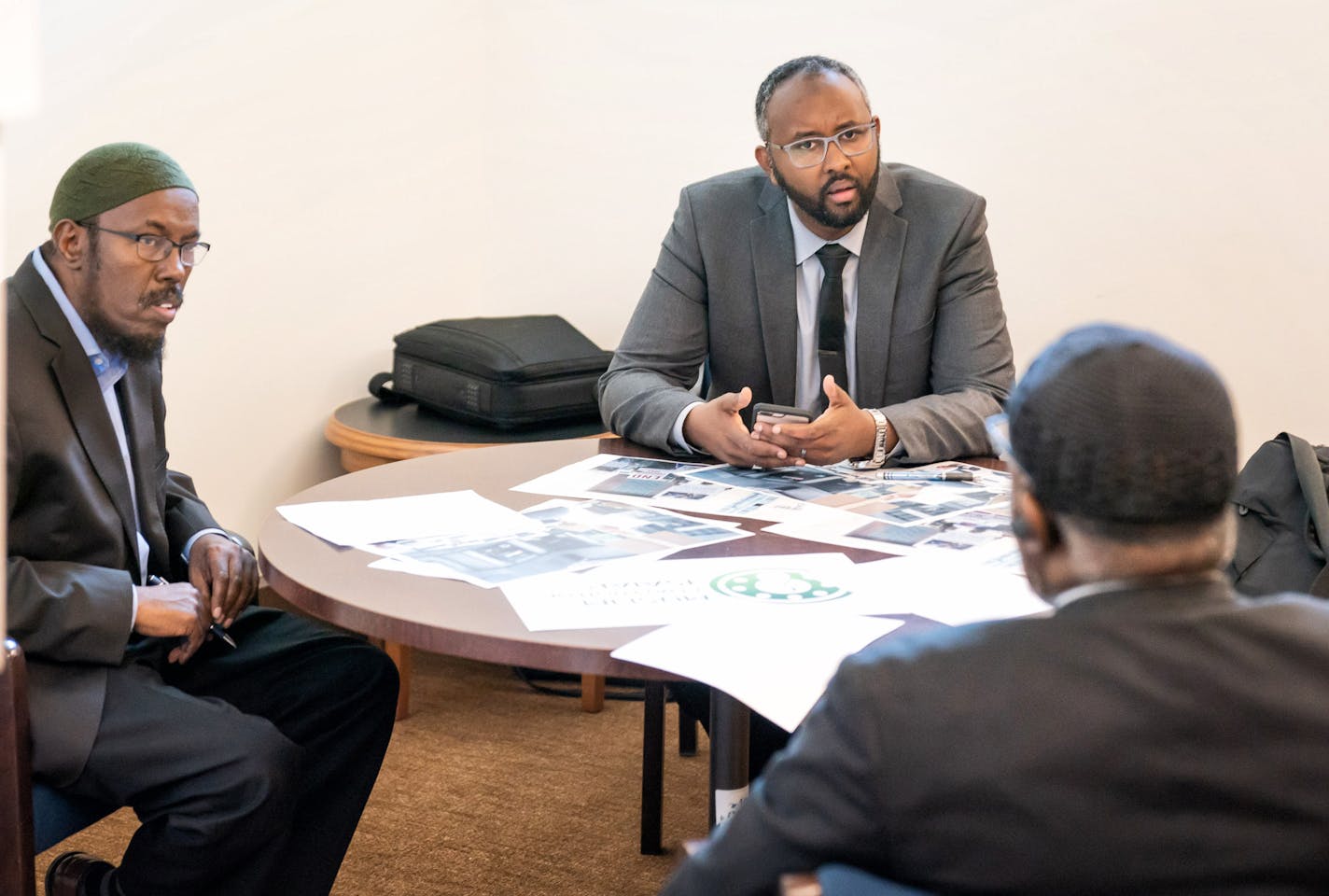 Abdulaziz Sugule, head of Somali American Money Services Association, Jaylani Hussein, executive director of CAIR-Minnesota, and Imam Hassan Mohamud, religious leader of Islamic Dawah Center discussed strategy before their press conference at the Capitol. Somali-American business leaders and Muslim faith leaders objected to what they called scapegoating and grandstanding by some Republican politicians over reports of briefcases full of cash they say are their only way of sending cash to their fa