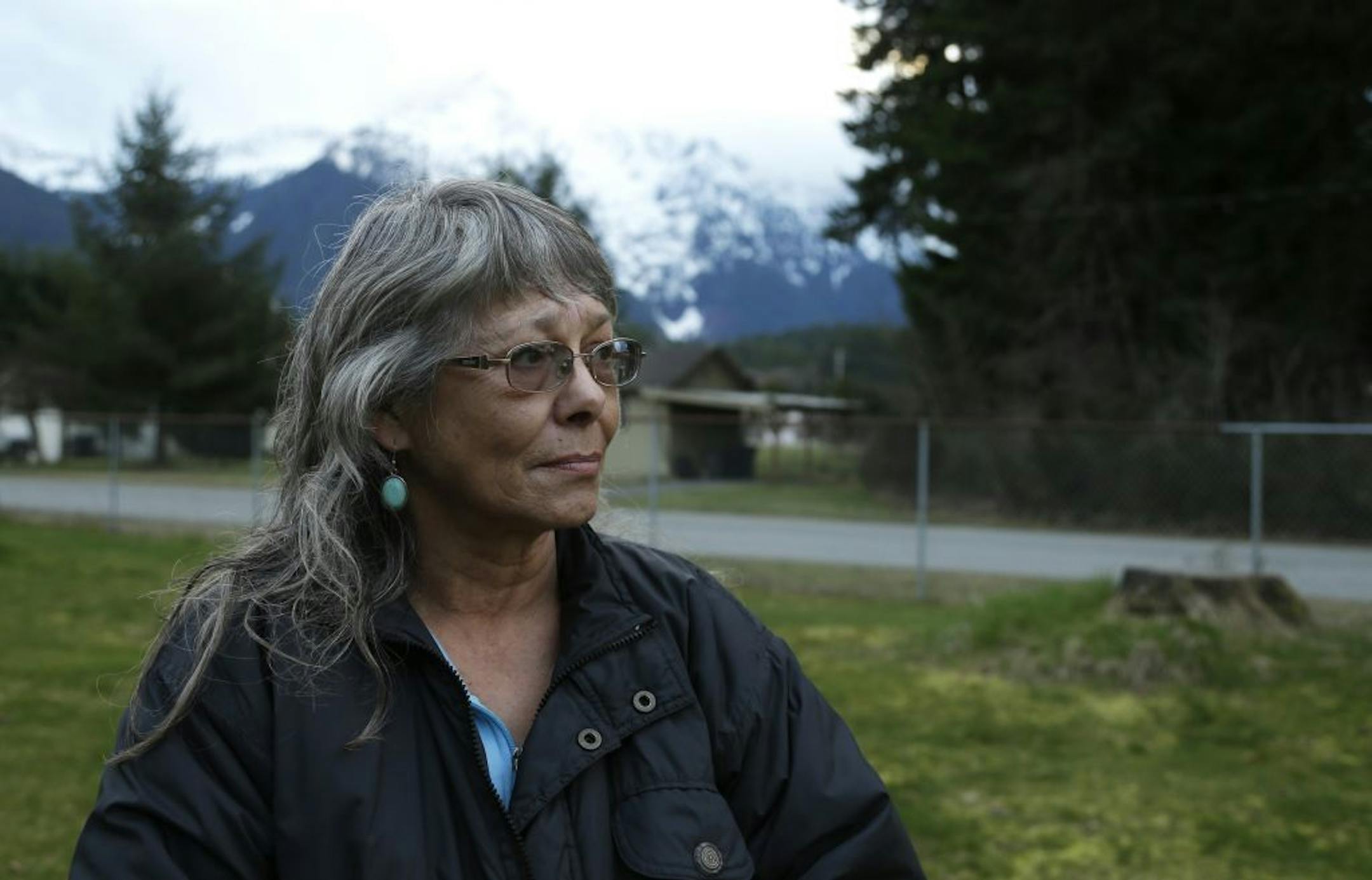 Robin Youngblood poses for a photo Thursday, March 27, 2014, with Whitehorse Mountain behind her in Darrington, Wash.